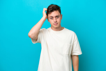 Fototapeta premium Young handsome Brazilian man isolated on blue background with an expression of frustration and not understanding