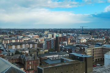 Fototapeta premium Panoramic view of Dublin from the Gravitiy bar in Guinness Storehouse in Ireland. Dense urban environment with a variety of buildings. Fermentation plant for the Guinness brewery. Aerial perspective