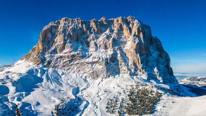 Forcella del Sassolungo, nestled in the Val Gardena ski resort, reveals its stunning winter beauty in this aerial drone capture. Located near the iconic Piz Sella
