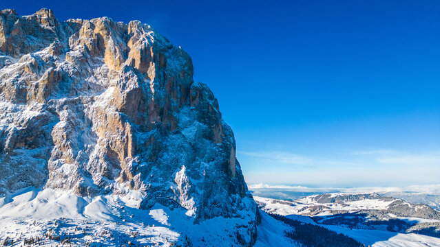 Forcella del Sassolungo, nestled in the Val Gardena ski resort, reveals its stunning winter beauty in this aerial drone capture. Located near the iconic Piz Sella