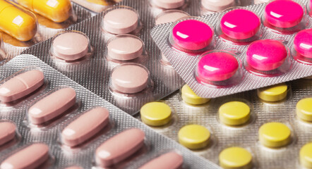 Various medicines, colorful pills in plastic packaging.