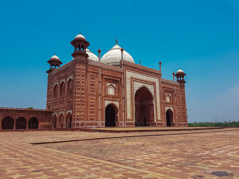 Beautiful architecture of the Taj Mahal mosque in Agra, Uttar Pradesh, India. Mosque is stunning example of Mughal architecture, with its red sandstone facade. Central dome and four minarets. Tourism