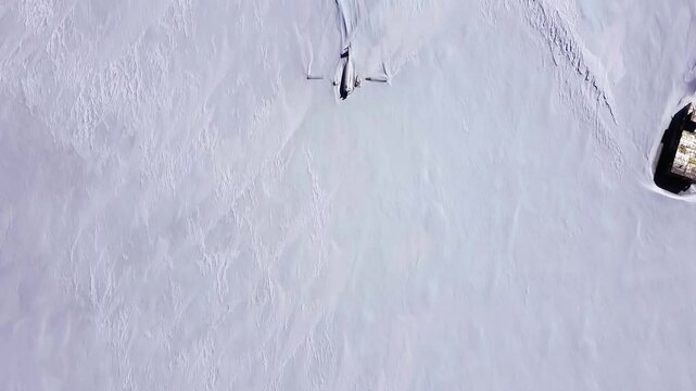 Broken abandoned aircraft covered in snow. Wreckage of the plane left in Antarctica. Ecological disaster. Pollution of the Earth. Aerial shot. Top view.