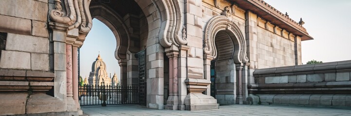 Ancient stone archway with temple view.