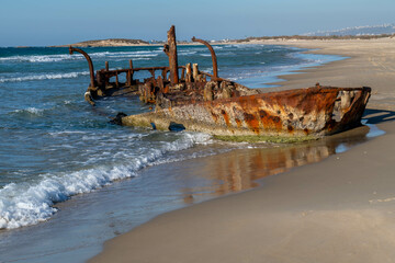Abandoned rusty shipwreck at HaBonim Beach Nature Reserve on the Mediterranean Sea in Israel.
