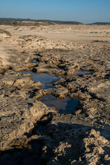 Small pools in the lava rock, basalt, at Habonim Beach Nature Reserve on the Mediterranean Sea in Israel.
