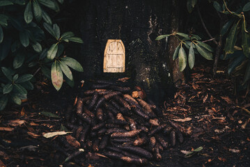 Cute mouse house in a tree with a mushroom and pine tree cones