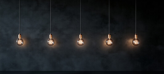 Obraz premium glowing light bulbs hanging from a wall.