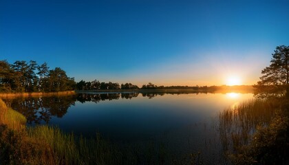 Obraz premium Generated image Panoramic view of a tranquil lake at twilight with a golden sunset, calm water, and distant