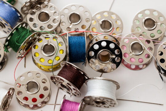 Assorted spools of thread for sewing projects.