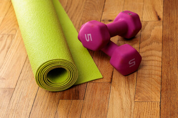 Fitness essentials: yoga mat and dumbbells.
