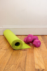 Yoga mat and dumbbells ready for a home workout.