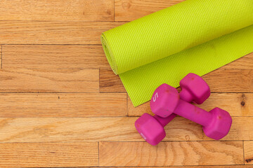 Home fitness essentials: yoga mat and dumbbells.