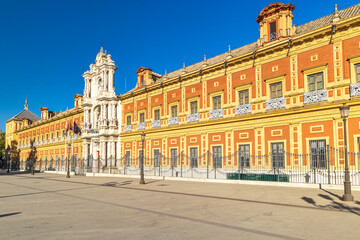 Fototapeta premium The Palace of San Telmo in Seville town, capital of Andalusia in Spain. Grand historical building on a sunny day. Elegant architecture and a wide plaza.