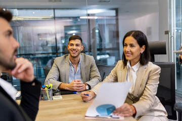 Workers group and team leader having teamwork discussion managing project at work in meeting room.