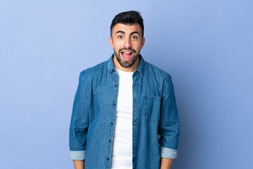 Caucasian man over isolated blue background with surprise facial expression