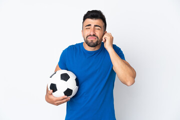 Handsome young football player man over isolated wall frustrated and covering ears