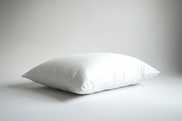 Soft, fluffy pillow resting on minimalistic surface, evoking com