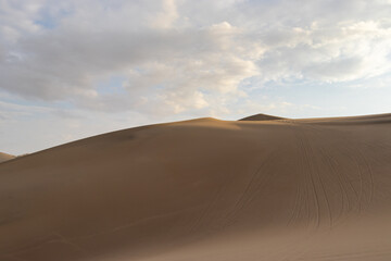 The sand dunes of Huacachina, Peru are a very popular tourist spot, where many try sandboarding or driving dune buggies.
