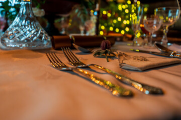 Elegant Festive Table Setting with Crystal Glassware, Cutlery, and Ambient Holiday Lights