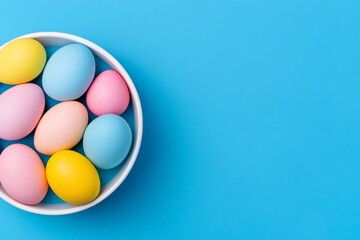 Fototapeta premium A straw basket filled with painted Easter chicken and quail eggs, seen from above