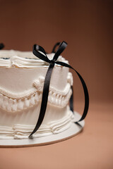 Fototapeta premium white cake decorated with cream and bows