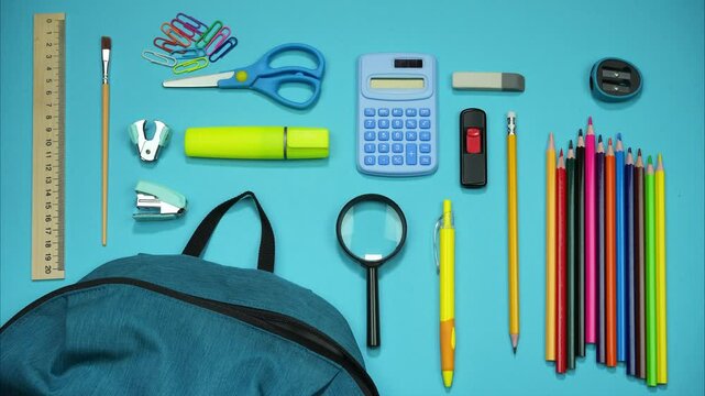 Blue background with a school backpack from which school supplies are funny crawling out and returning.