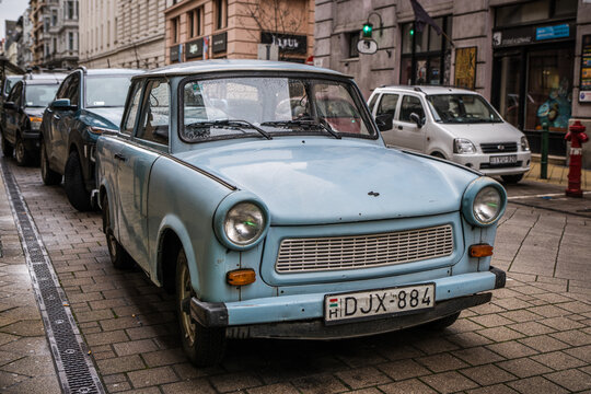 Budapest, Hungary - January 22, 2023: A blue Trabant 601 parked on a city street, surrounded by modern vehicles, in downtown Budapest.