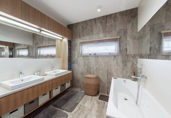 Bright Elegant Modern Bathroom Interior Design of White Bath, Sink, Mirror. Bathroom Accessories, Gray Tile Walls, LED Light.