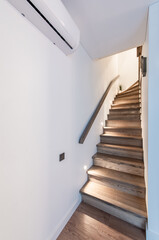 Modern Wooden Minimalism Style Stairs With Discrete Floor Night Lighting. New Wooden Staircase in Apartment House With Modern Interior Design