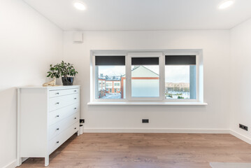 Home office room interior. Wooden Floor, Windows, Door. Bright White Color Walls and Ceiling. Flower on the chest of drawers