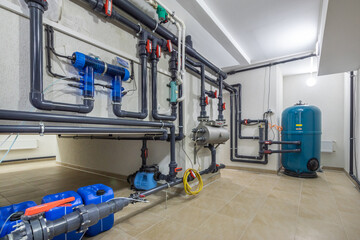 Fototapeta premium Complex wiring of pipelines with sensors, switches, pressure gauges in the interior of a .modern boiler room.