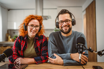 portrait of two radio hosts smile and enjoy while record podcast