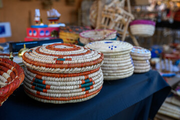 DOHA, Qatar - November 29, 2023: The 13th Katara Traditional Dhow Festival. Close-up of small, multi-colored handmade baskets on display for sale, high-quality image.