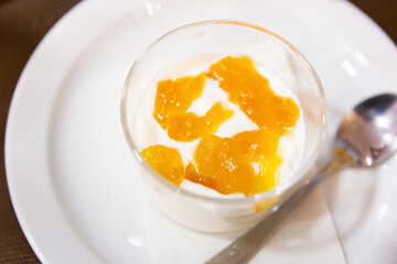 Yogurt with passion fruit marmalade served in glass for dessert