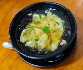 Wonton soup is cooked dumplings filled with meat or seafood. They are served in broth, usually...