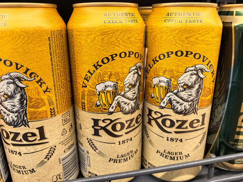 Golden lager cans with unique goat design showcasing Czech brewing tradition