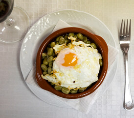 Appetizing fried eggs with beans and ham served for breakfast