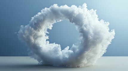 Cloud shaped as ring, rests on pale surface.