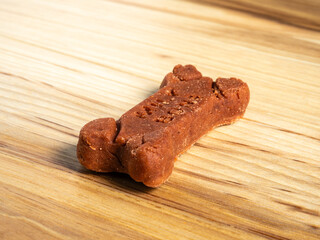 Closeup of red milkbone dog treats on wooden board