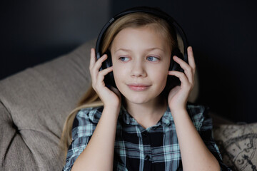 Portrait of girl listening to music. Relaxing in Living Room