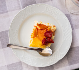 Piece of sweet strawberry cheesecake served for dessert on plate