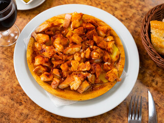 Delicious octopus galician style served with potatoes on plate