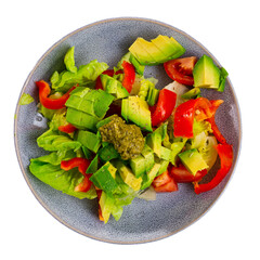 Plate contains portion of salad of fresh seasonal vegetables, complemented by small carafe of olive...