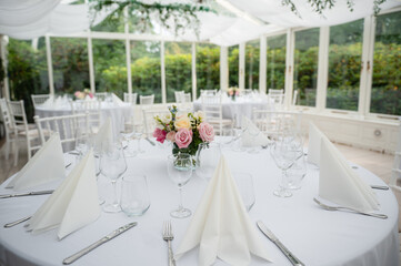 White stylish decorated restaurant interior with natural lighting for minimalist wedding celebration near the garden, no people, empty