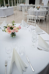 White stylish decorated restaurant interior with natural lighting for minimalist wedding celebration near the garden, no people, empty