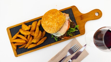Delicious cheeseburger with beef patty and cheese on a plate, with french fries