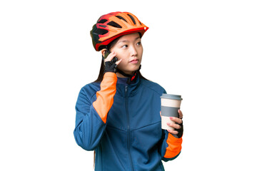Young cyclist woman over isolated chroma key background holding coffee to take away and a mobile