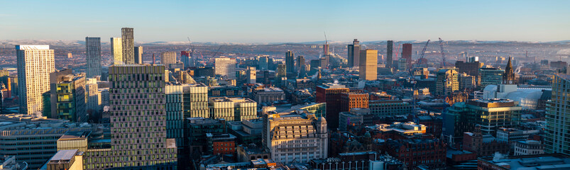 Panoramic aerial image of frosty Manchester skyline at sunrise. 