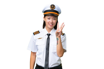 Airplane pilot Asian woman over isolated background happy and counting three with fingers